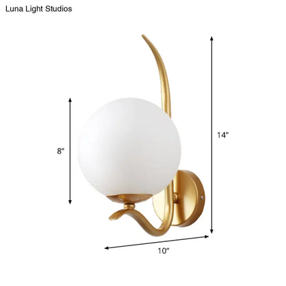 Modernist gold sconce light with white glass shade and curved metal arms suitable for 220v-240v bedroom use