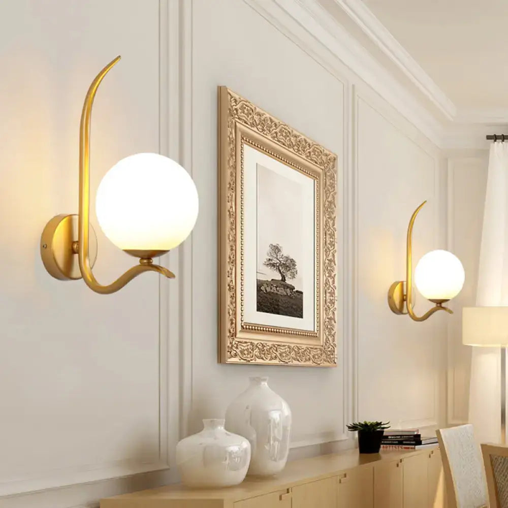 Modernist gold sconce light with a curved arm and white glass frosted globe shade for bedroom 220v-240v