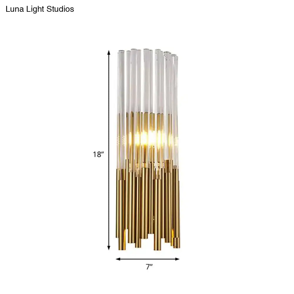 Modernist gold and clear cylinder wall light fixture with glass tubes and warm LED illumination for bedroom use