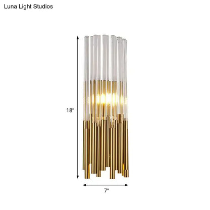 Modernist gold and clear cylinder wall light fixture with glass tubes and warm LED illumination for bedroom use