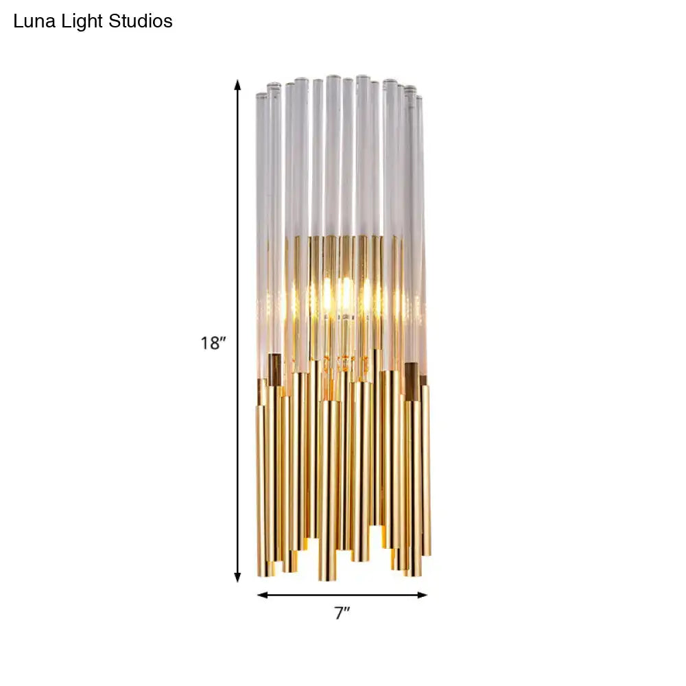 Modernist gold and clear cylinder wall light fixture with glass tubes and warm integrated lighting for bedroom use