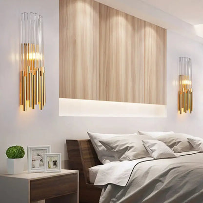 Modernist gold and clear glass cylinder wall light fixture with elegant design ideal for bedroom wall sconce use