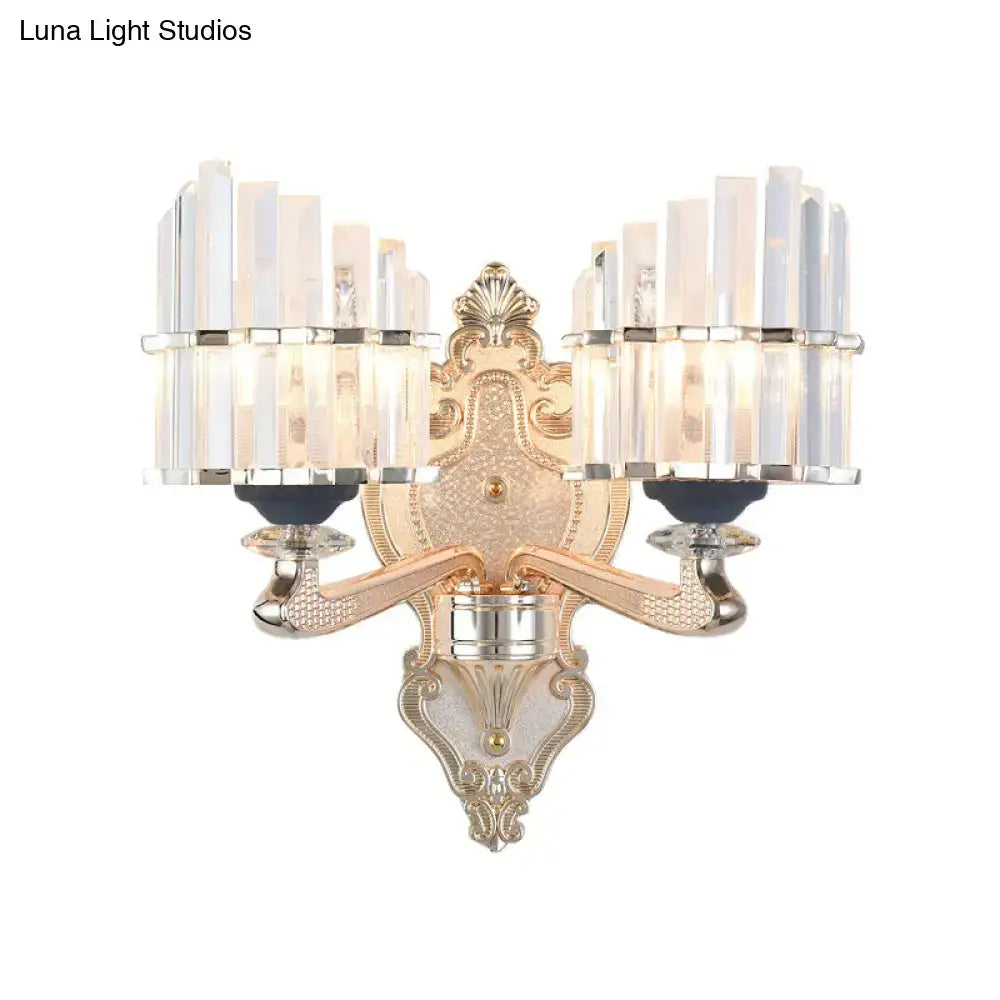 Ornate gold and silver two-light wall light with crystal vertical rods and conical shade for living room use