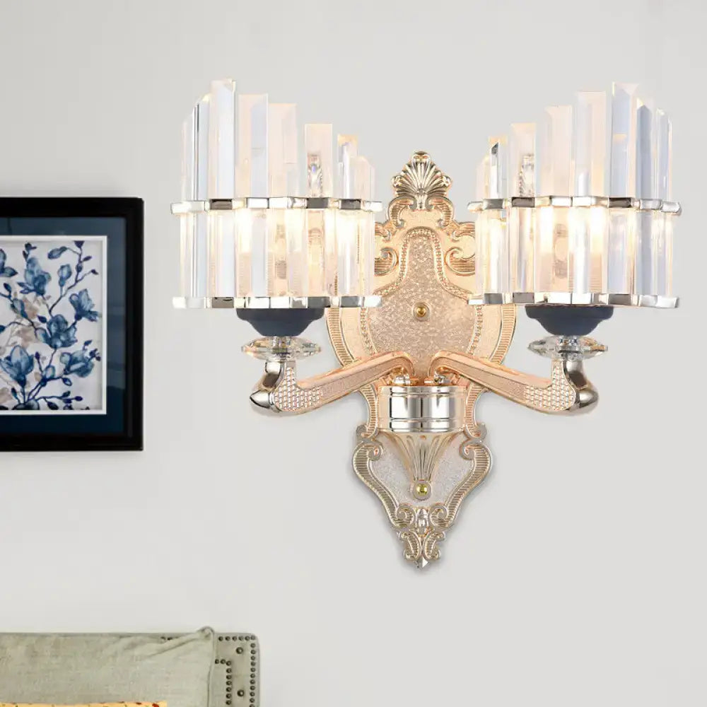 Ornate gold and silver wall light with crystal accents and conical shade for elegant living room decor