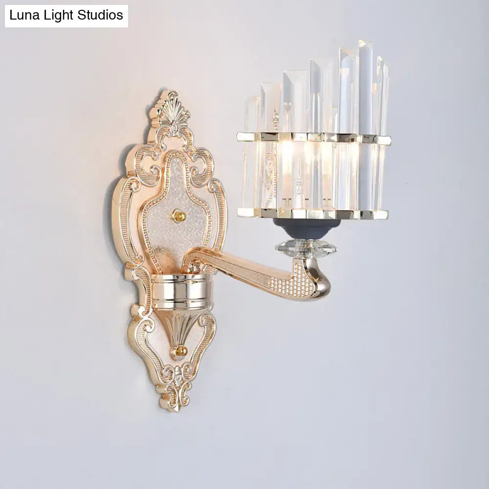 Modernist gold wall light with ornate crystal accents and curved arm featuring a conical shade for living room use