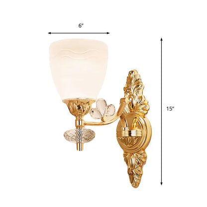 Modernist gold finish wall light with ornate crystal accents frosted glass shade and standard bulb base for bedroom use