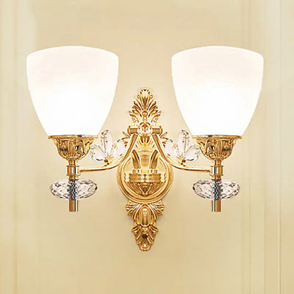 Modernist gold finish wall light with crystal accents and two frosted glass bulb base shades for bedroom sconce