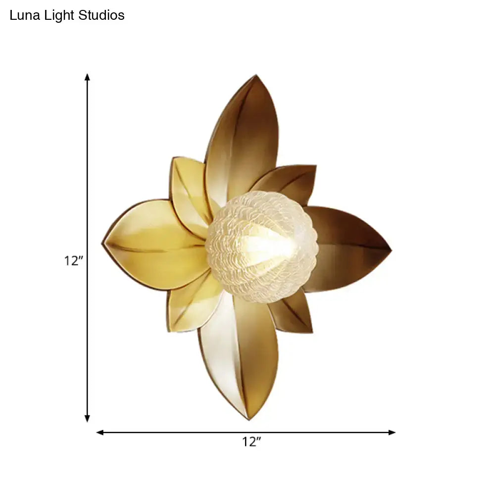 Modernist gold-toned metallic lotus-shaped wall sconce with textured frosted glass center light fixture for bedroom use