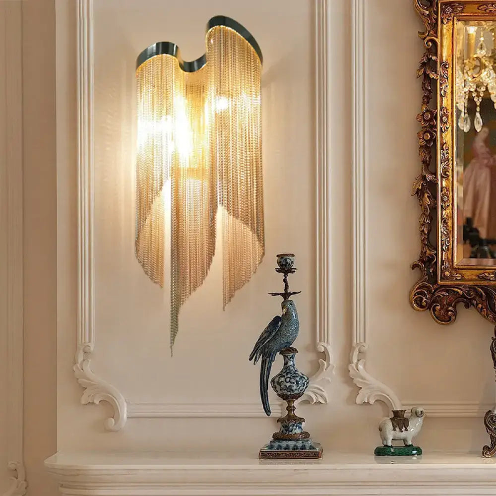 Modernist gold and silver aluminum tassel wall sconce with golden chain curtain and wing-like metallic frame for living rooms