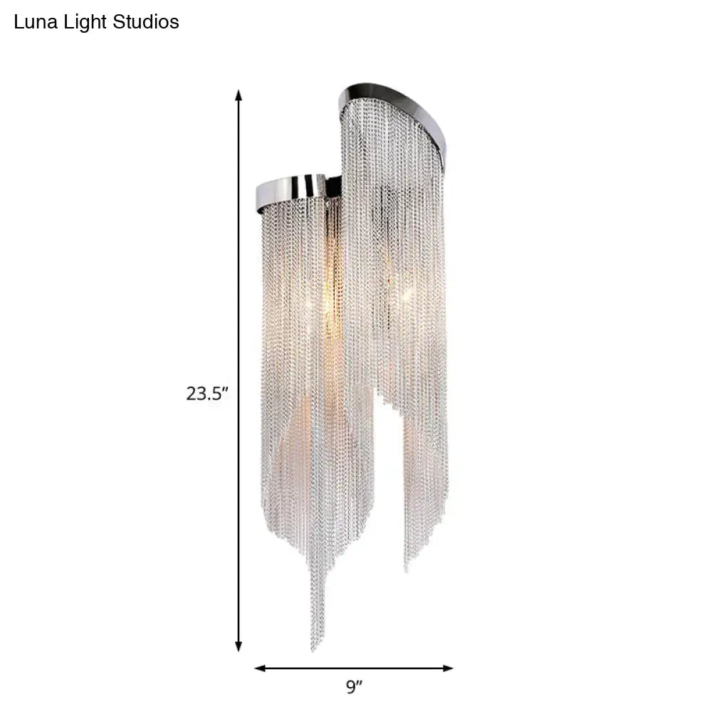 Chrome-finished aluminum tassel wall sconce with cascading silver chain fringe for modernist living room lighting