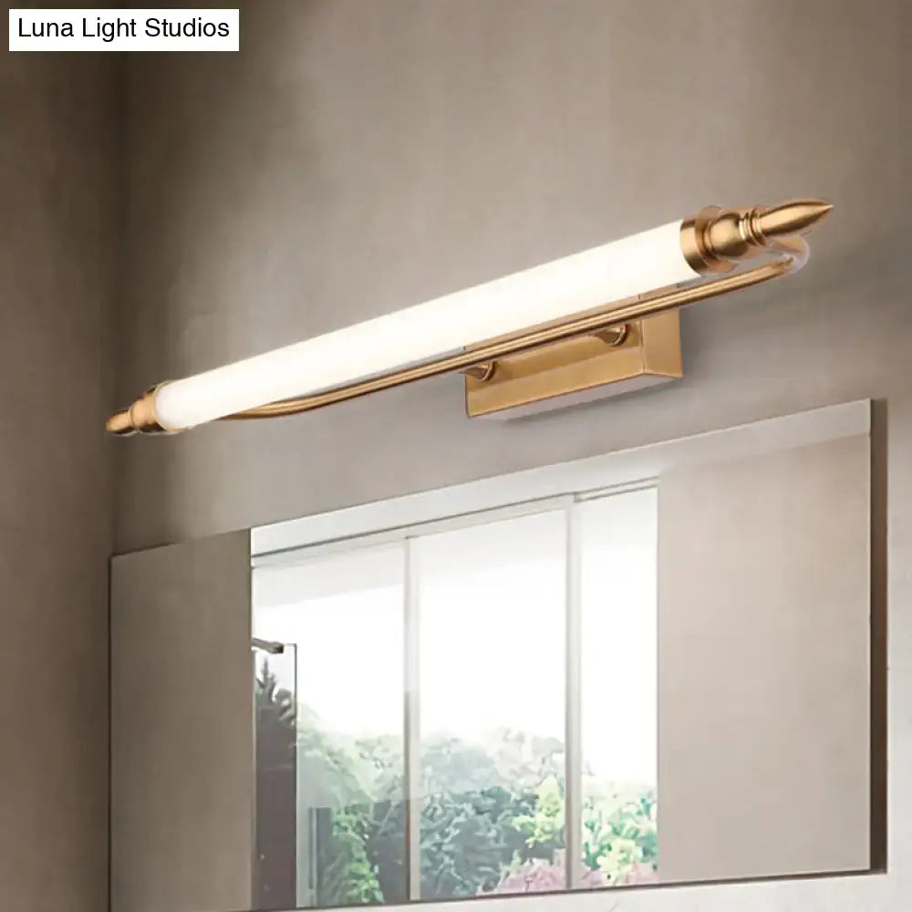Gold-finished tube metal vanity wall light with frosted glass diffuser and ornate spearhead ends for bathroom