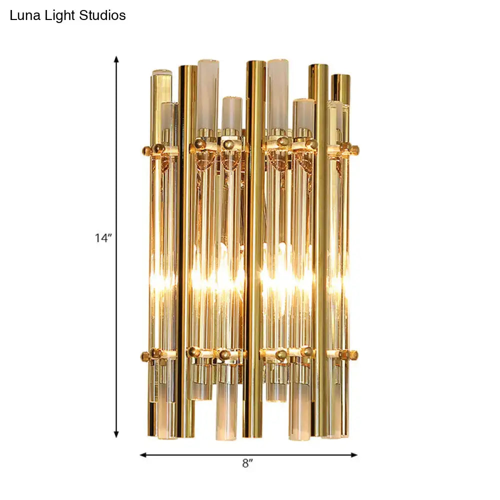 Gold-toned modernist tubular wall sconce with vertical glass tubes and frosted accents for bedroom lighting