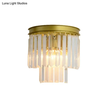 Modernist gold wall lamp featuring clear faceted crystal prisms designed for elegant living room lighting