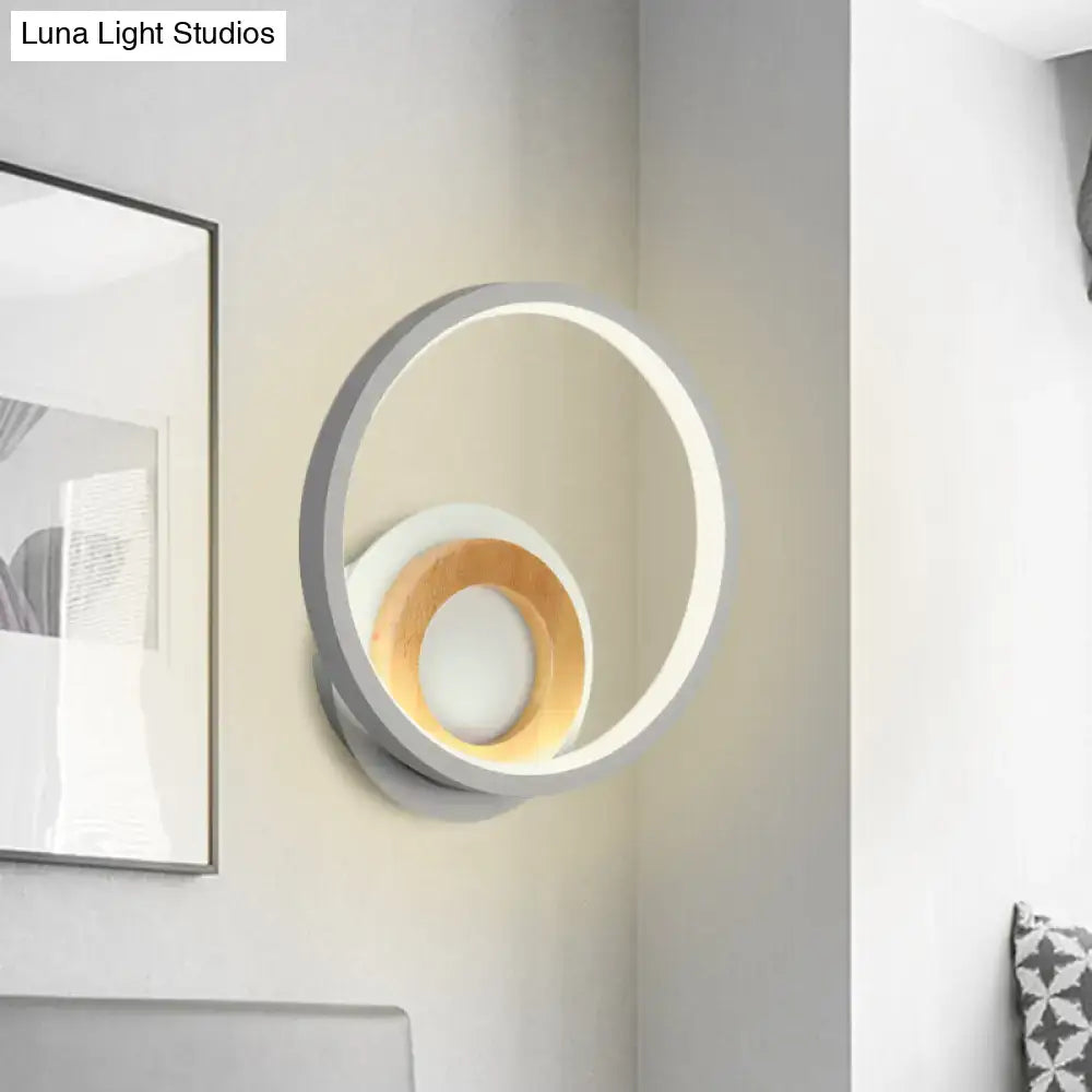 Modernist gray and wood ring wall sconce with sleek outer ring and warm wood accent ideal for bedroom led lighting
