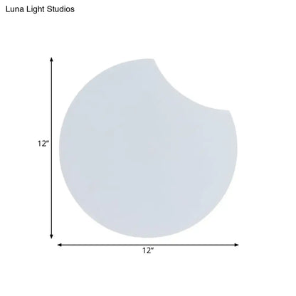 Modernist gray circular wall mount light with 12-inch white acrylic pan and bite-sized notch on right side