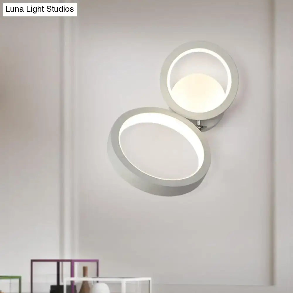 Modernist matte beige double ring wall lamp with a sleek white circular led sconce for bedroom corners