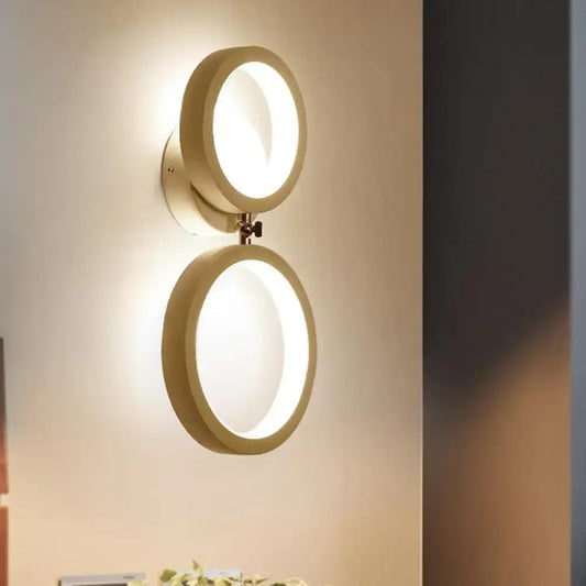 Modernist matte beige double ring wall lamp with warm minimalist design ideal for bedroom corners
