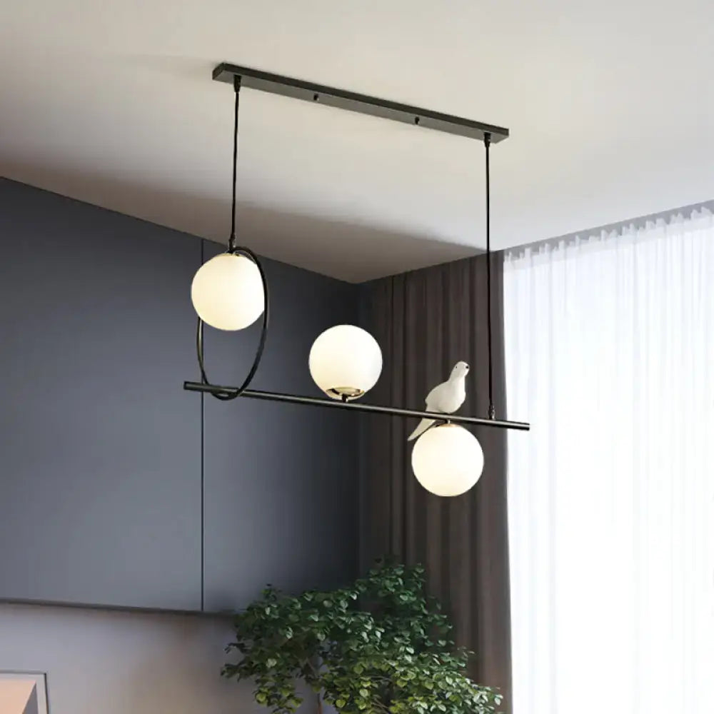 Modernist milk glass pendant black dining room light with three frosted globe bulbs and decorative white bird accent 220v-240v