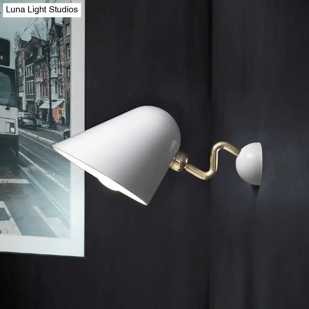 Modernist off-white ceramic wall mounted sconce with a gold-toned rotating node and wide flare articulated arm