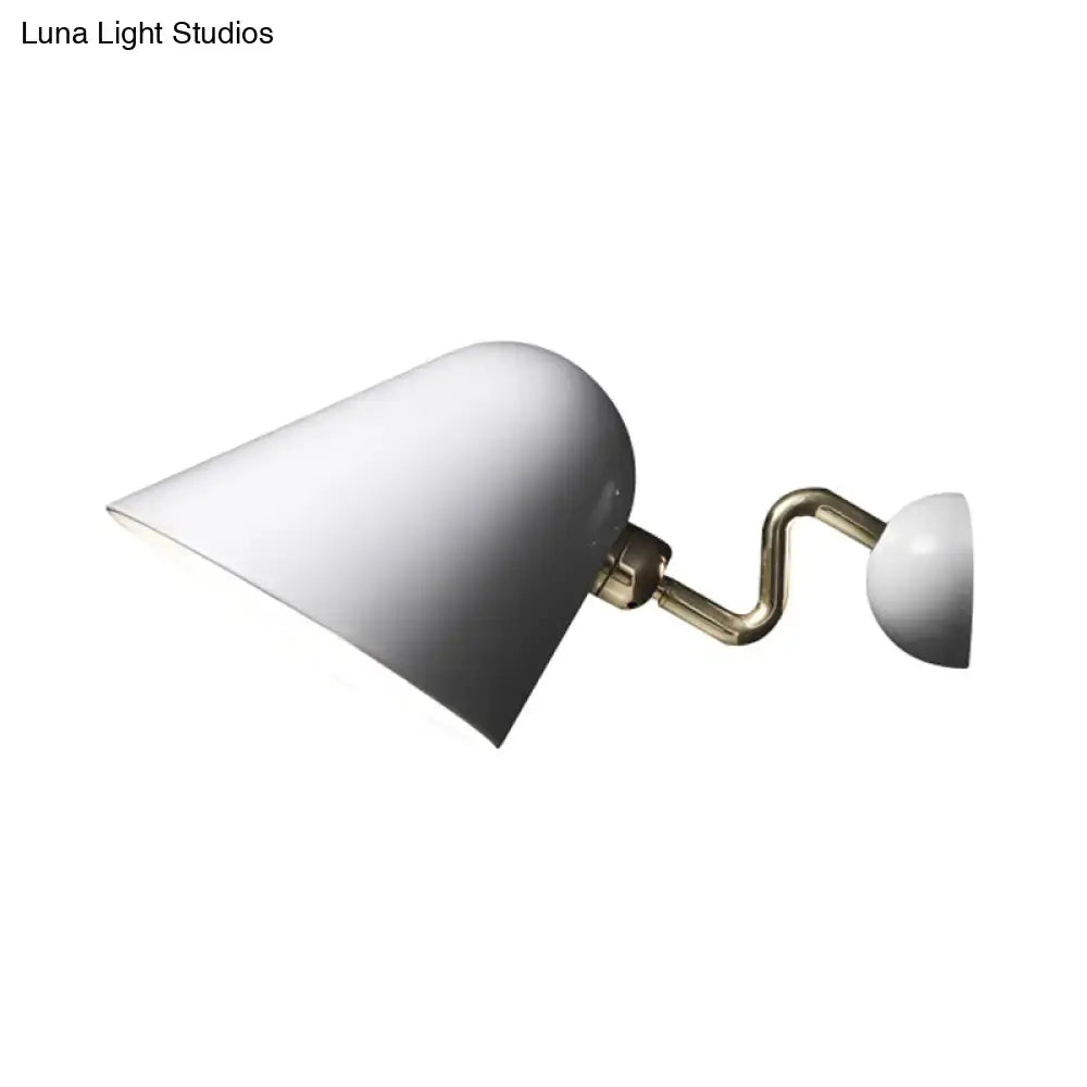 Modernist off-white wall mounted sconce with wide flare white matte conical shade and rotating node brass arm fixture
