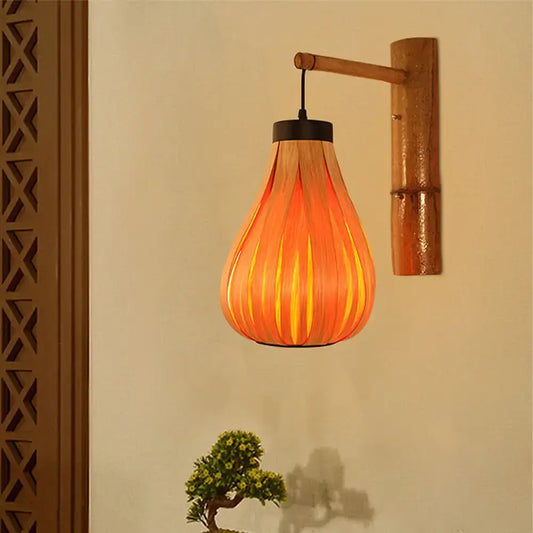Modernist orange wood slat wall sconce featuring warm lantern design with vertical slats and bamboo wall mount