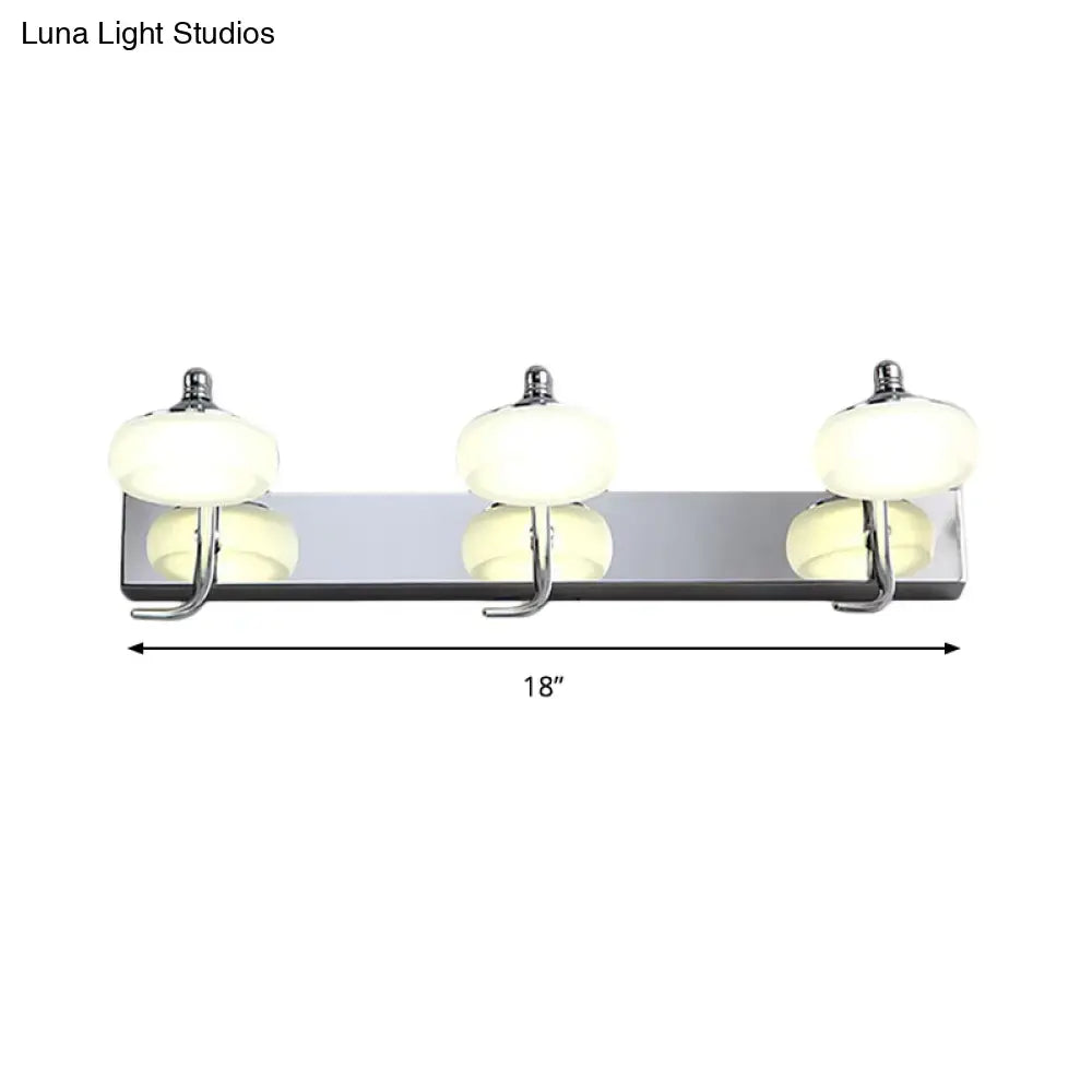 Modernist silver bathroom vanity light with chrome finish, frosted acrylic shades, and matching hooks wall lamp