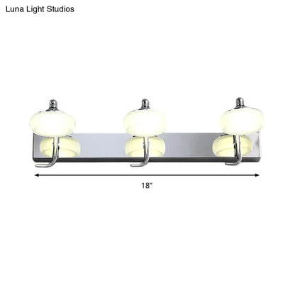 Modernist silver bathroom vanity light with chrome finish, frosted acrylic shades, and matching hooks wall lamp
