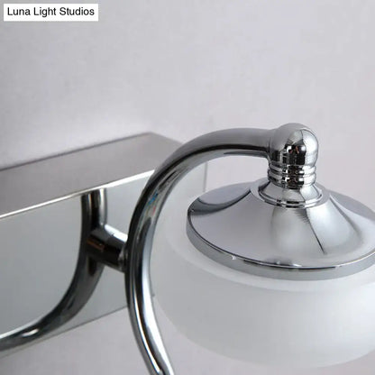 Modernist silver bathroom vanity light with chrome finish, frosted acrylic shades, and elegant curved arm wall lamp