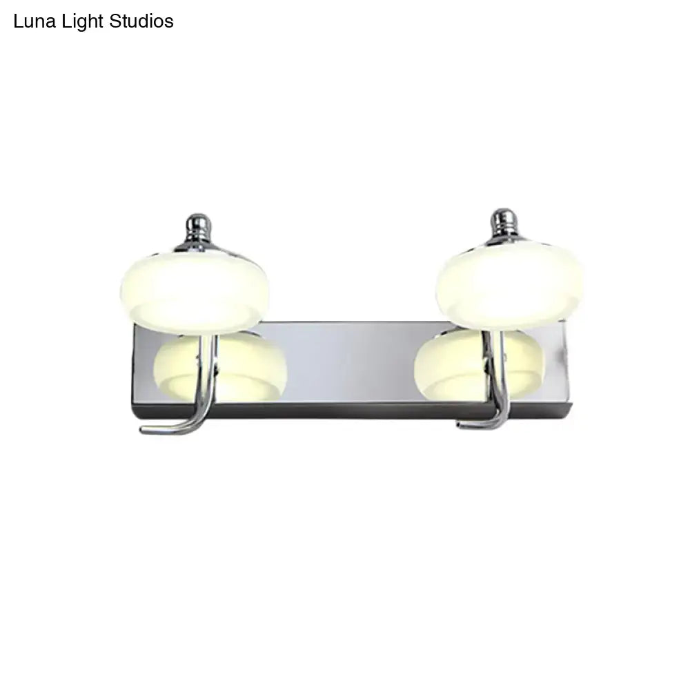Modernist silver bathroom vanity light with frosted acrylic globe shades and chrome wall lamp featuring integrated hooks