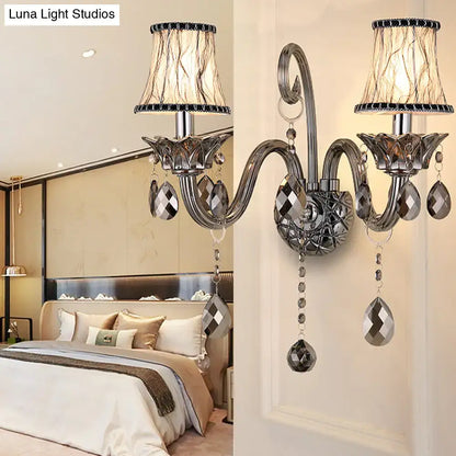Silver-toned smoke grey crystal wall mounted lighting with ornate curved arms and faceted teardrop crystals for living room