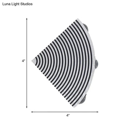 Modernist striped black and silver wall lamp with concentric black and white stripes and sleek metallic finish for living room