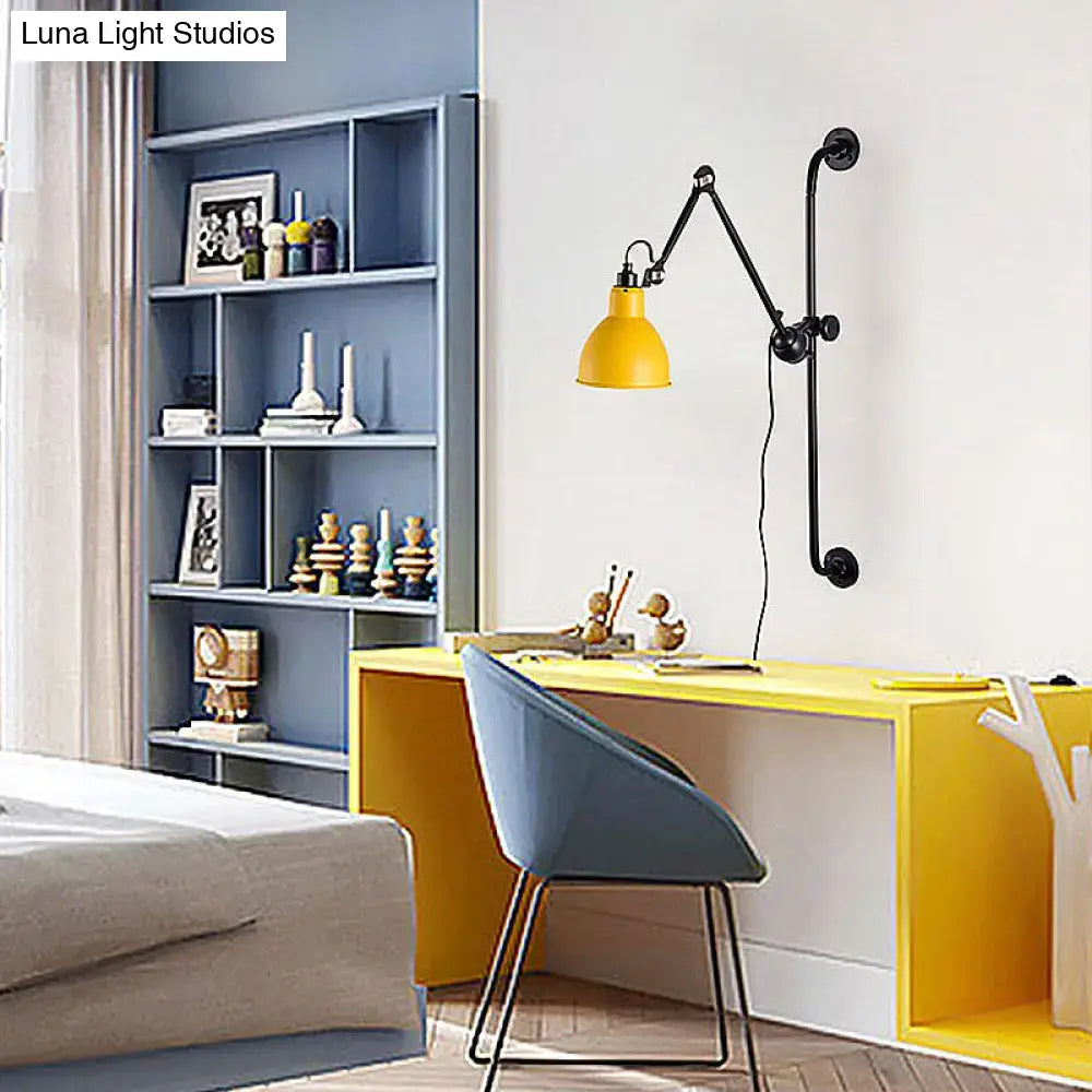 Yellow industrial-style wall light with black articulated arm and pipe mounting bracket for modernist style dining room