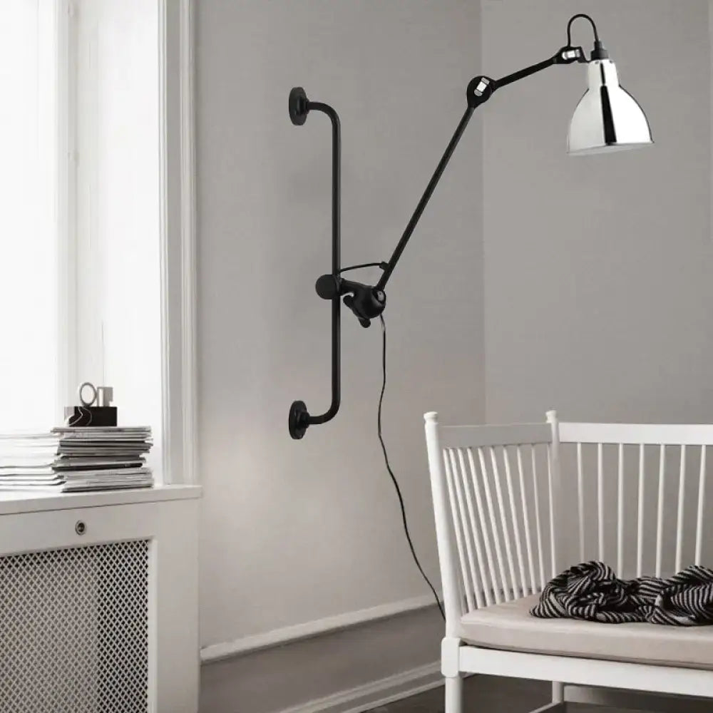 Modernist style black wall light with articulated arm and polished chrome shade for dining room lighting