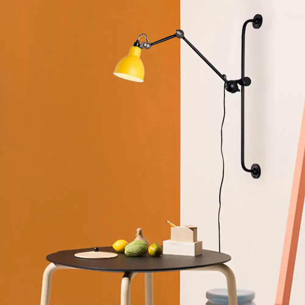 Yellow industrial wall light with black articulated arms and matte finish in modernist style black white design for dining room