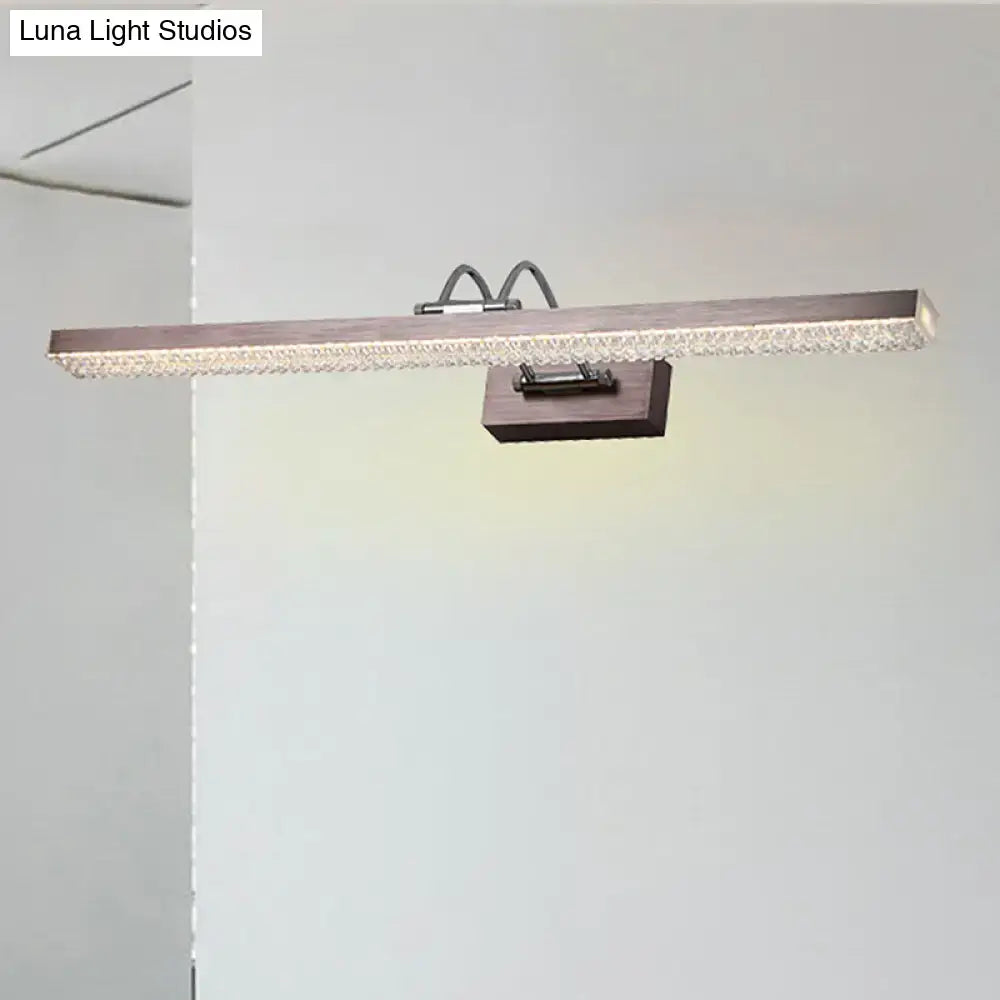 Modernist wall light featuring a rectangular led vanity light with dark wood finish and crystal accents for bedroom use