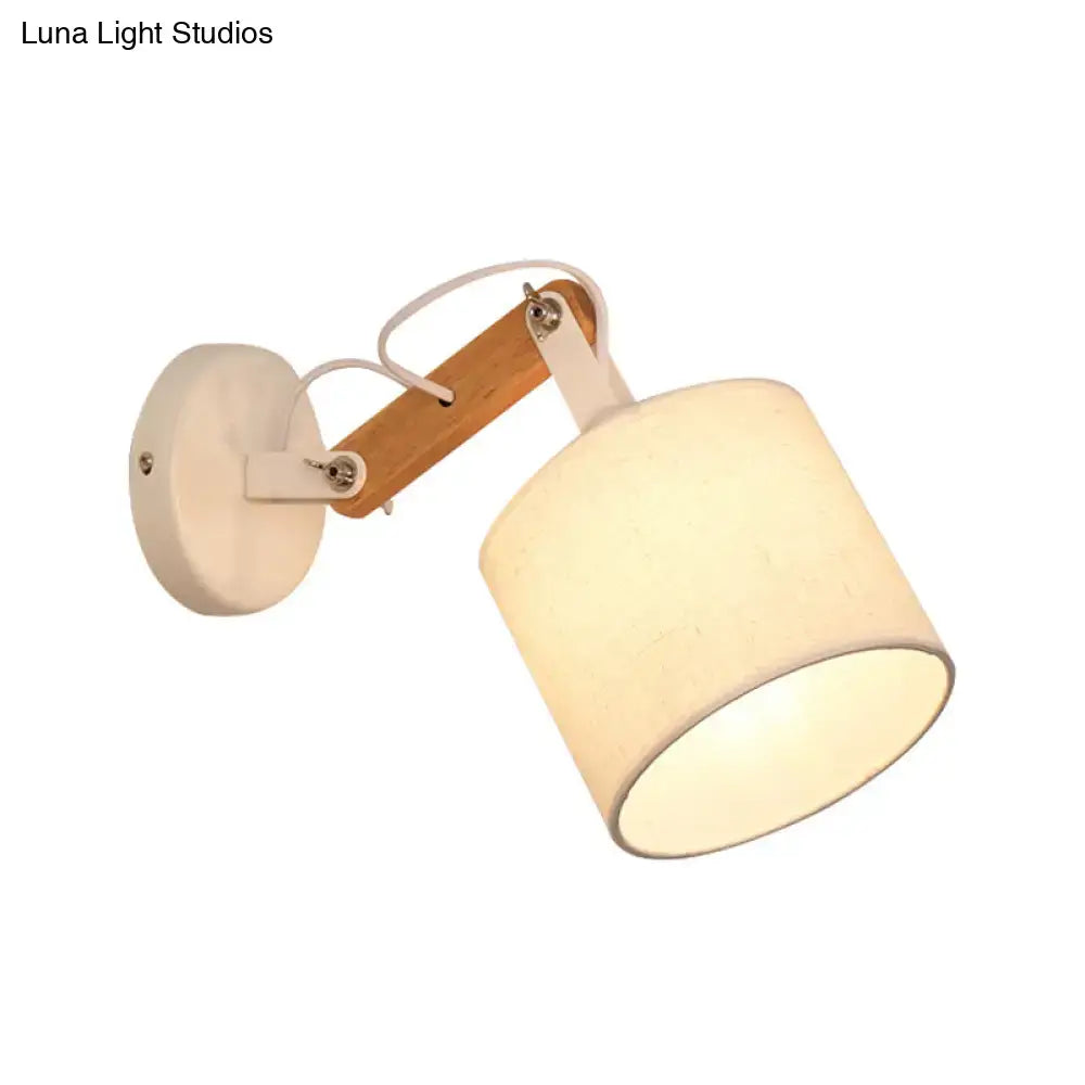 Minimalist wall lamp with cylindrical off-white fabric shade, adjustable wood arm, and 220v-240v 110v-120v compatibility