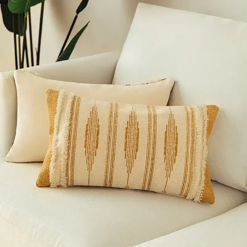 Cream-colored rectangular cushion cover set with mustard yellow geometric patterns and frayed edges for living room