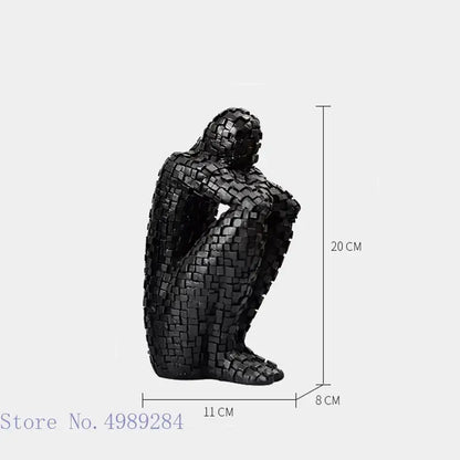 Black mosaic-style golden man thinker figurine crafted from interlocking square tiles for living room decor