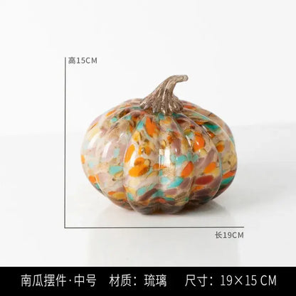 A vibrant mosaic orange and teal transparent glazed pumpkin sculpture with metallic stem for home decor