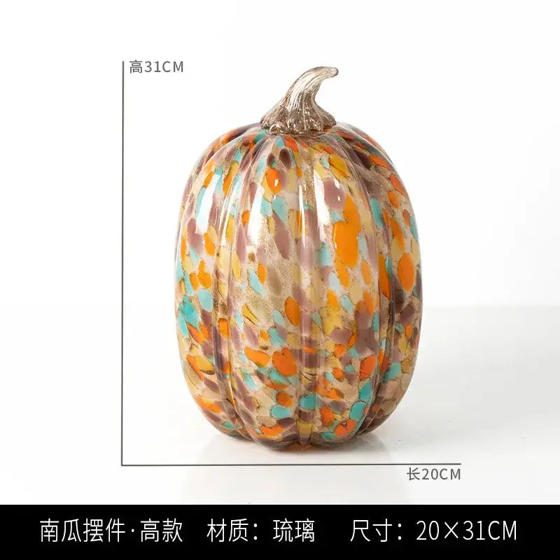 A vibrant transparent glazed pumpkin sculpture in orange teal with metallic stem for living room home decor