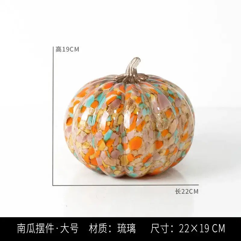A vibrant mosaic orange and teal transparent glazed pumpkin sculpture with a metallic stem for home decor