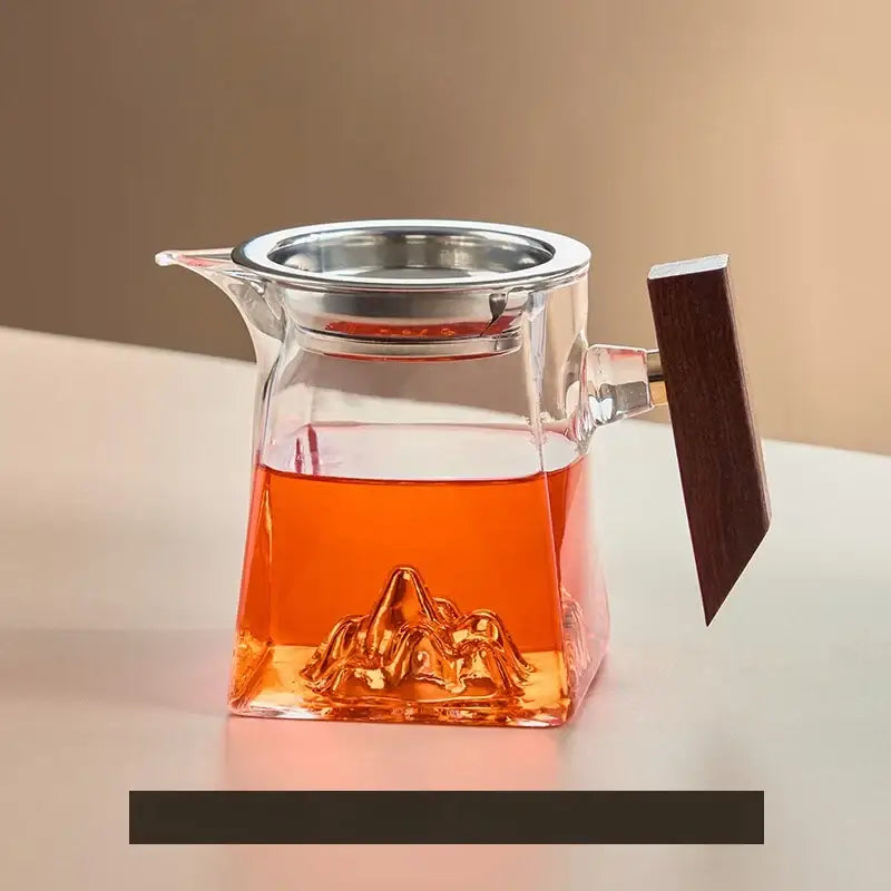 Clear glass tea cup set with a mountain-shaped base stainless steel lid and wooden handle for dining room use