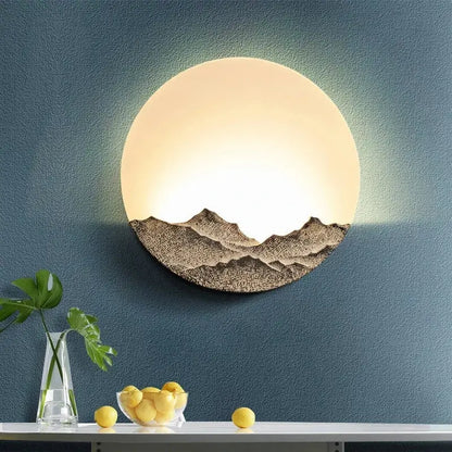 Mountain landscape led wall light by decorbites featuring a warm glowing upper half and textured earthy tones design