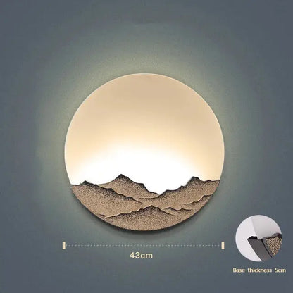 Circular mountain landscape led wall light with warm glow and textured brown silhouette for bedroom decorbites led wall decor