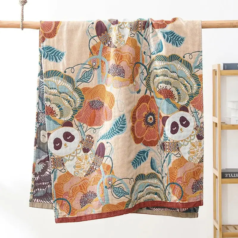A soft beige bath towel with a vibrant multicolor design featuring florals and pandas by decorbites gauze flower bath