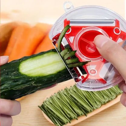 Red and clear plastic magic peeler with rotating blade from the multicolor magic peeler trio set for slicing and shredding