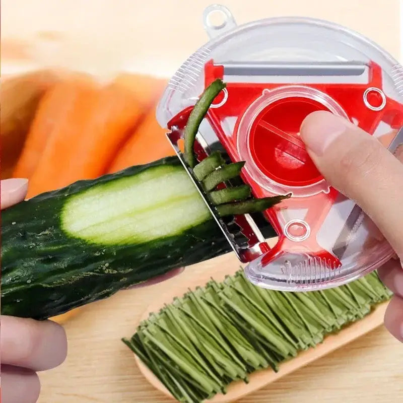 Red and clear plastic magic peeler with rotating blade from the multicolor magic peeler trio set for slicing and shredding