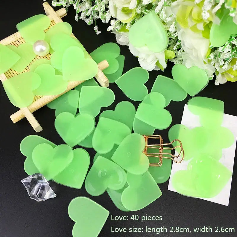 Luminous green heart-shaped acrylic cutouts with pearl accents and gold clips for stars glow dark wall bedroom decor