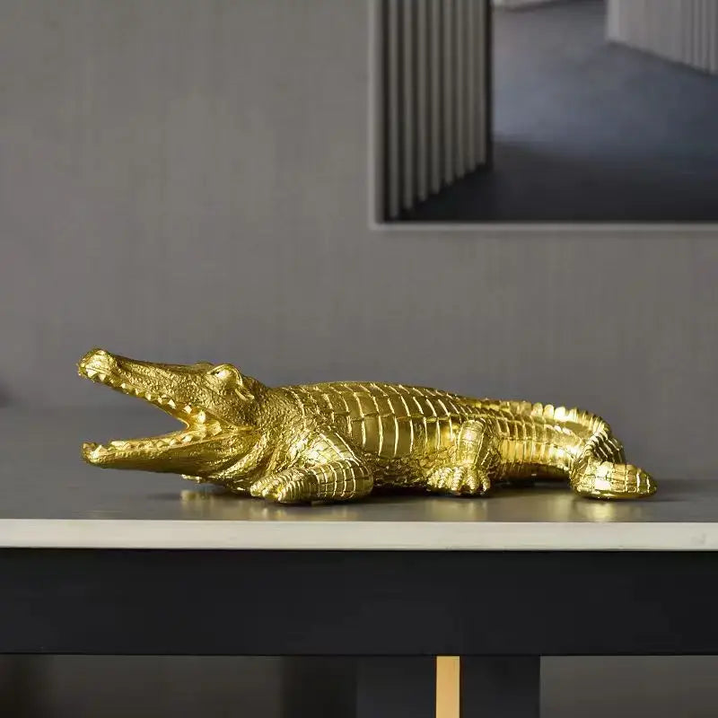 Golden crocodile wildlife sculpture with detailed scales and open mouth on sleek surface for living room decorbites decor