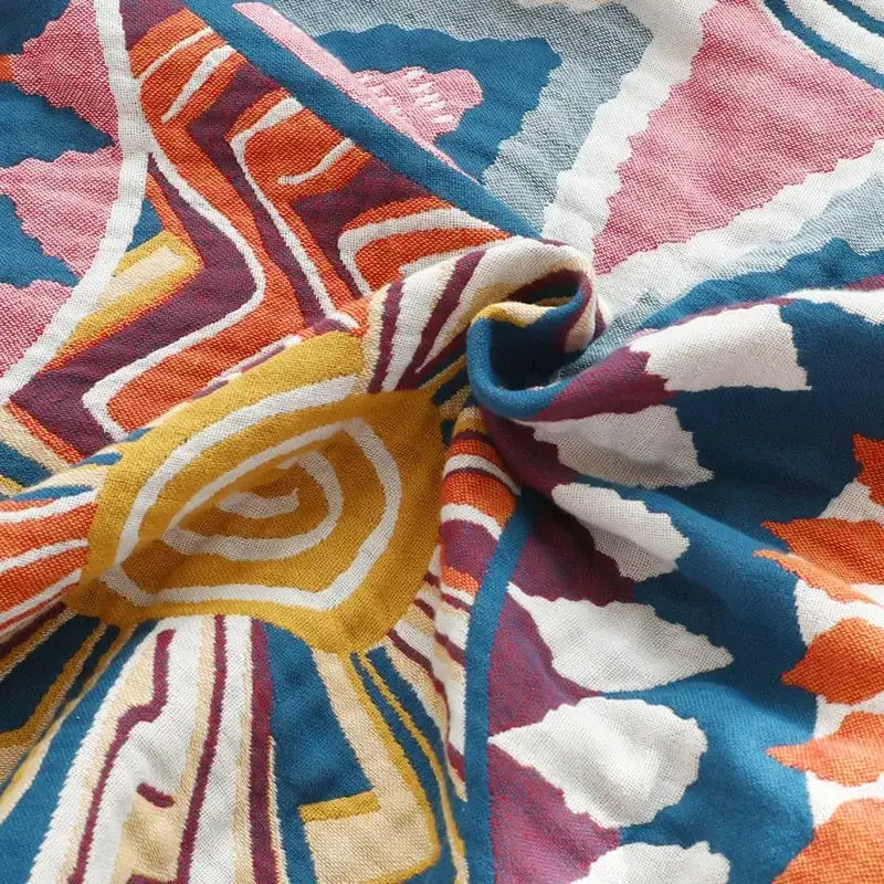 A vibrant multicolored cotton gauze boho throw blanket with bold geometric pattern for bedroom or living room decorbites cotton gauze